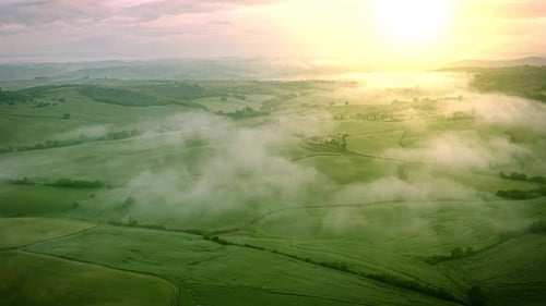 Flying over the foggy Tuscany Italy landscape