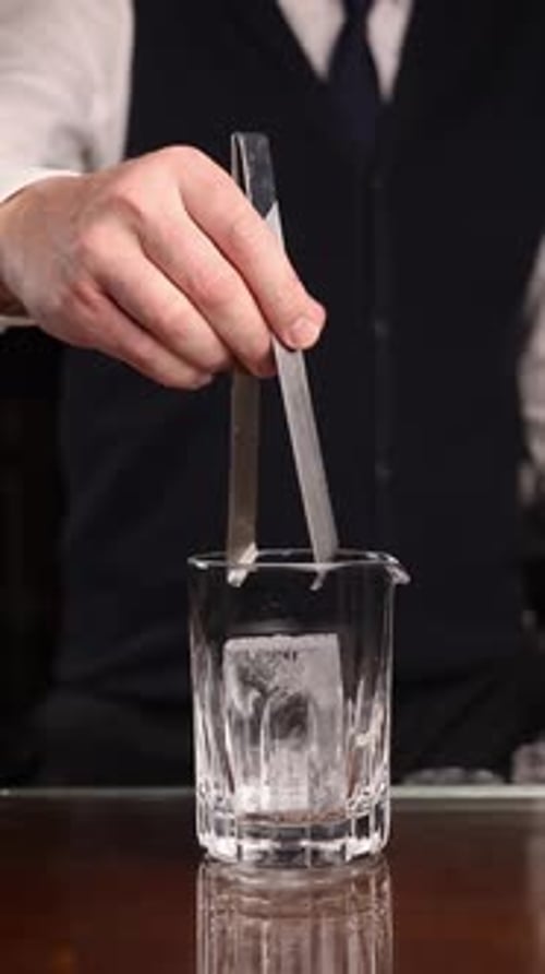the bartender prepares a popular cocktail at the bar
