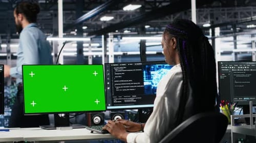 Female Technician and Coworker in Data Center Review AI Diagnostics on Mockup PC