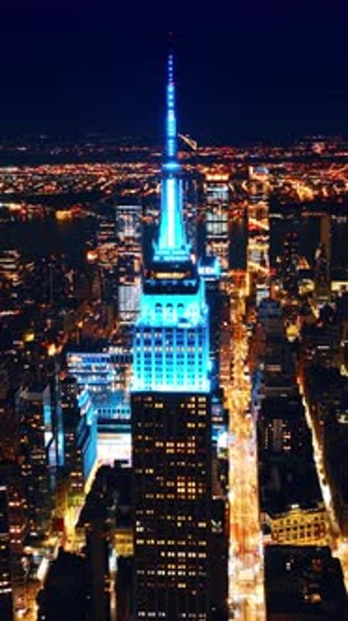 American commercial buildings avenue. Night New York city aerial view. Vertical video