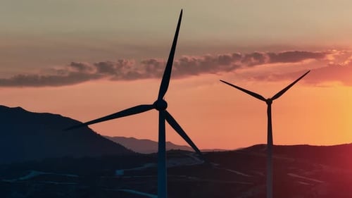 Serene Beauty From Above Captivating Aerial Footage of Windmills at Twilight