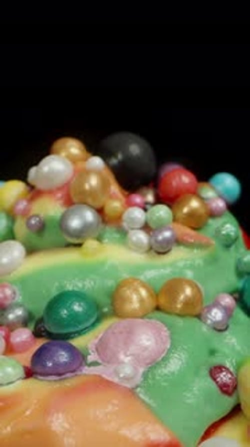 Extravagant Colorful Sprinkled Cupcake Against Black Background