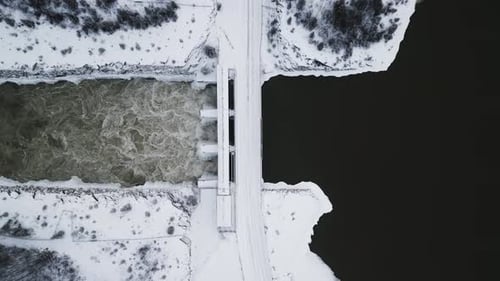 High Altitude Top Down Aerial Rushing Water Notigi Control Structure Hydro Dam River Lake Snowy Land