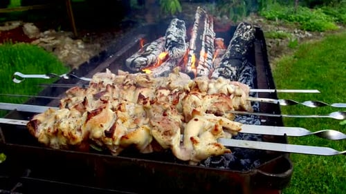 Grilled Chicken Cooking Over Charcoal on Barbecue