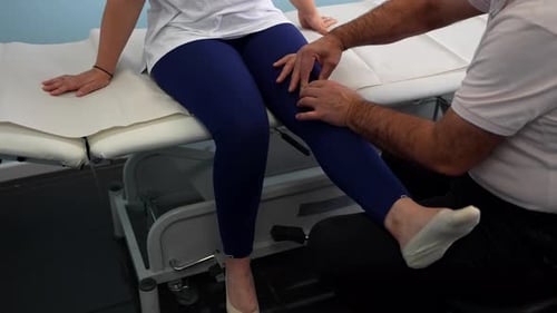 Doctor Checking Patient Reflexes During Examination