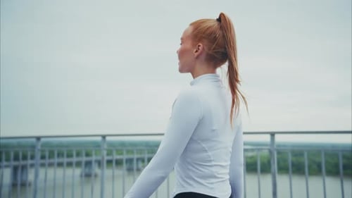 Woman Running on Bridge on Overcast Day
