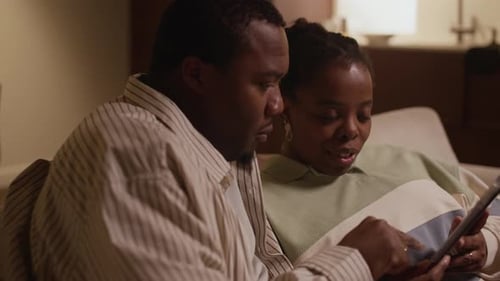 Loving Couple Relaxing at Home with Tablet
