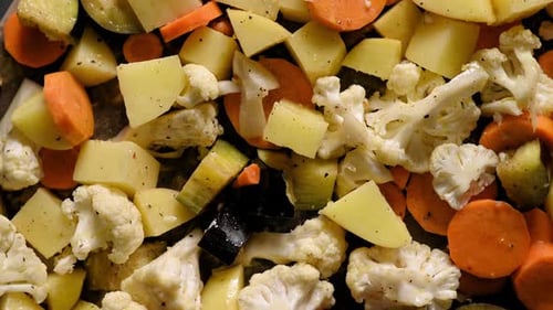 Close-up of chopped fresh summer organic vegetables potatoes, eggplant, carrots, cauliflower