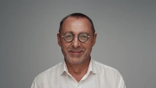 Smiling Man with Round Glasses