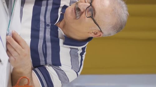 Vertical video of Home office worker old man happy and smiling.