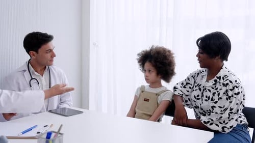 Doctor Talking With Patient in Medical Clinic