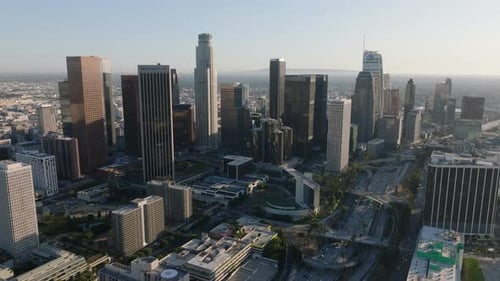 Aerial Slide and Pan Shot of Downtown Skyscrapers Against Clear Sky at Sunset Los Angeles California