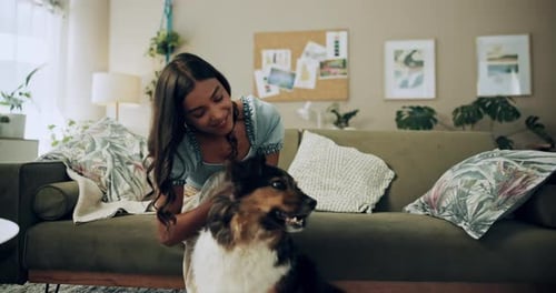 Woman Petting Dog on Living Room Floor