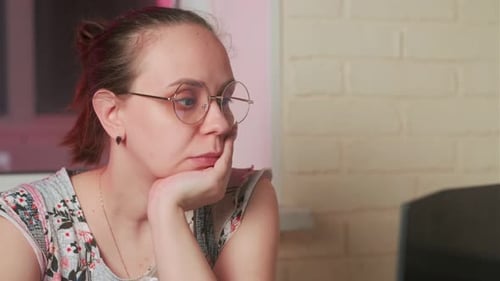 Thoughtful Woman with Glasses Inside