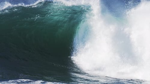 Ocean Wave Cresting and Breaking in Sunlight