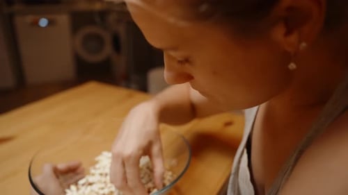 Young Adult Eating Popcorn at Home, Close Up