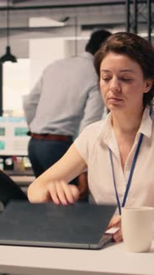 Vertical Video Female Worker Analyzing Income Data and Performance Metrics in Corporate Office