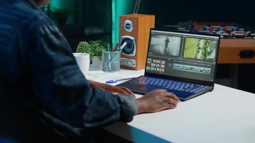 Woman Using Mouse to Edit Movie Project Footage in Apartment Office