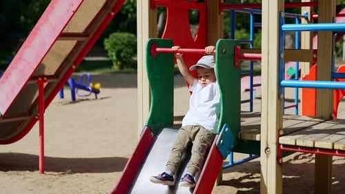 Happy Child Playing on the Slide