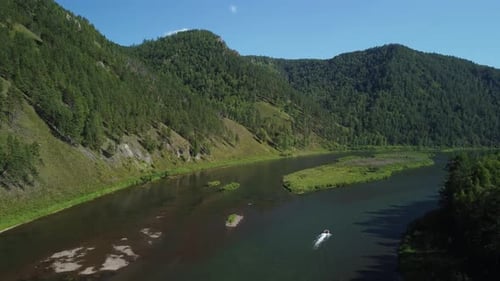 Awesome aerial view of boat floating on scenic river