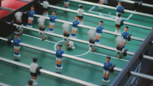 Friends Having Fun Together Playing Foosball. Colleagues Playing Table Football on Break