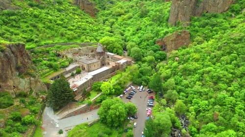 Geghard is medieval monastery in Armenia, carved into nearby mountain.