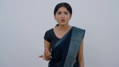 Woman Explains Point with Hand Gestures Indoors