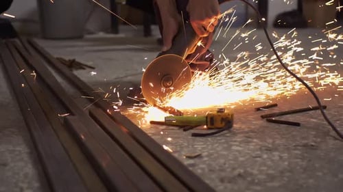 Cutting Iron With Grinder In Small Workshop