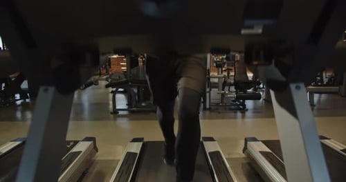 Experienced Athlete is Improving His Body Doing Cardio on Treadmill in the Gym
