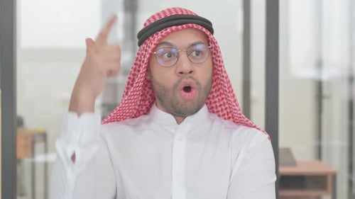 Man in Traditional Head Covering Having an Idea