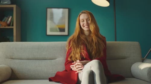 Woman sitting on couch in room