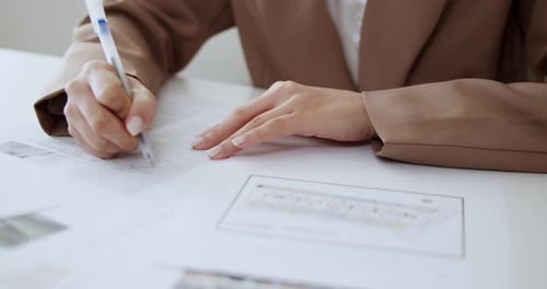 Portrait of Asian woman in neat clothes signing a work contract in the office.