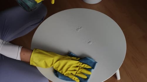 Woman wearing gloves cleaning around home, spring cleaning concept, yellow gloves