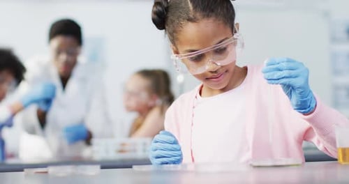 Diverse female teacher and happy schoolchildren having science class in school lab