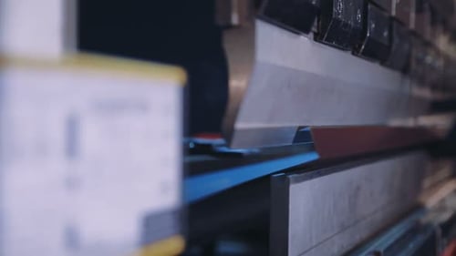 Pressing Sheet Metal on a Machine Tool Factory. Worker Puts the Steel