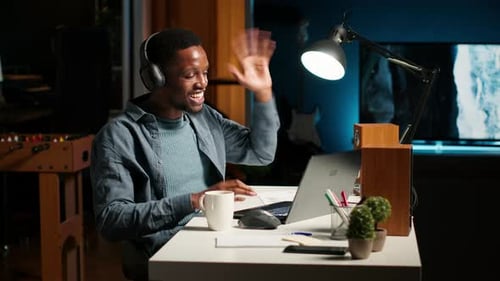 Young Focused Freelancer Attending an Online Meeting From His Home Office