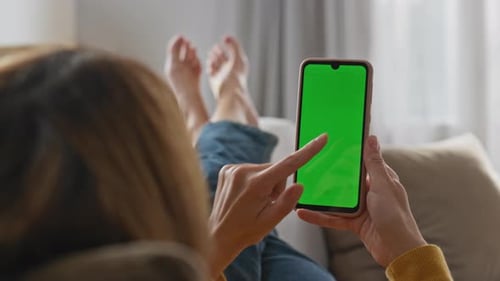 Woman Lying on Couch Using Smartphone with Green Screen