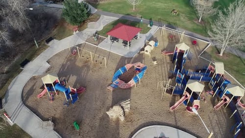 Descending tilt shift aerial of playground, no children due to COVID