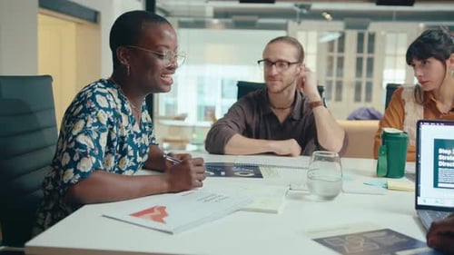 Female Business Leader Holding Meeting with Colleagues in the Office