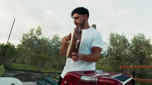 Musician Plays Percussion Instrument in Nature