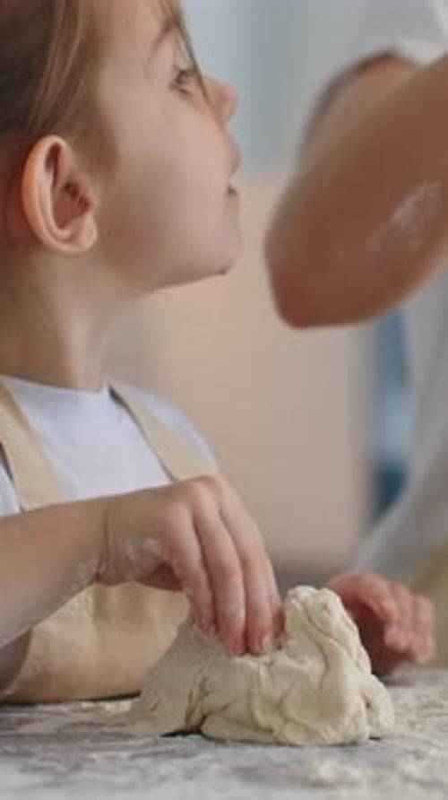 Curious Child Shaping Soft Dough with Tiny Hands on a Floured Kitchen Table Learning Baking Skills
