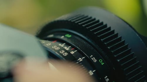 close up of old retro vintage film camera while a female hand turning the focus wheel