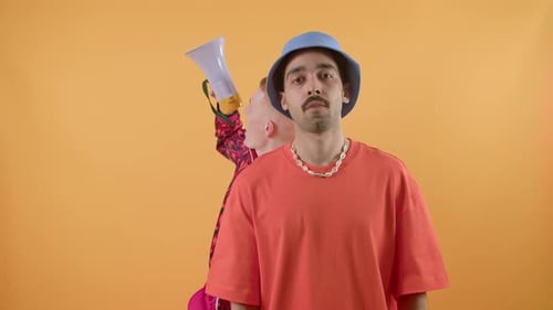 Two Young Adults with Megaphone and Skateboard
