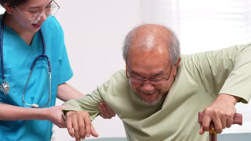 Caregiver Helping Senior Man in Hospital