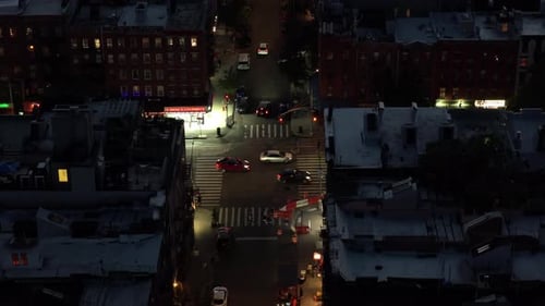 Aerial View of a Bustling New York City Intersection at Night Highlighting the Iconic Yellow Taxis