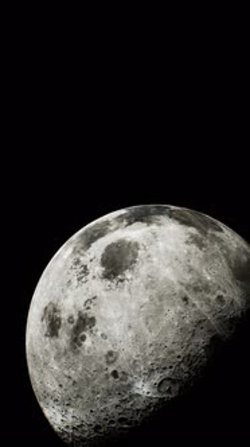 Sunlit Crescent of the Moon Visible From a Distance in Space Vertical