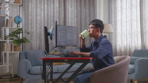 Adult Coding and Drinking Coffee at Home