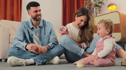 Happy Family Playing Together at Home on Floor