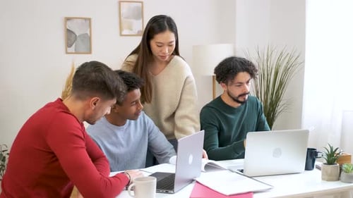 Group of University Colleague Studying Together at Shared Students House