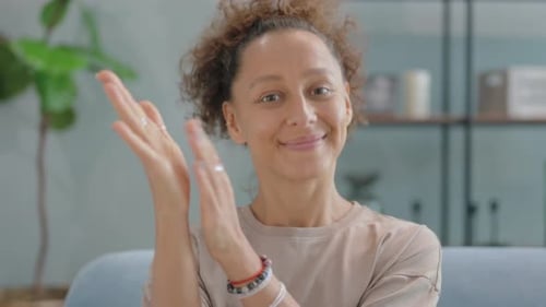 Woman Smiling and Clapping Indoors